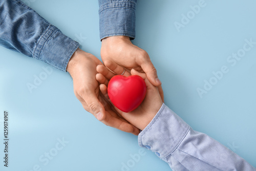 Couple holding heart on blu...