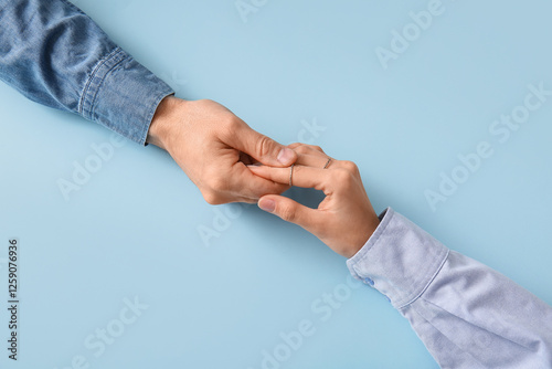 Couple holding hands on blu...