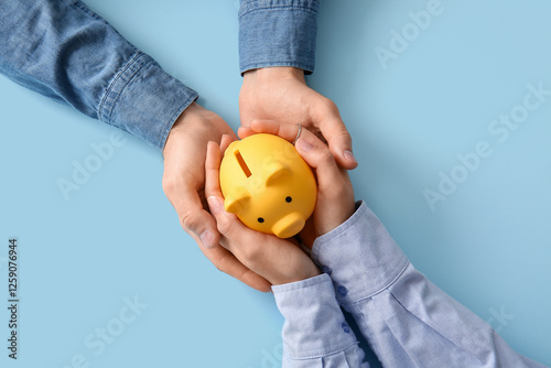 Couple holding piggy bank o...