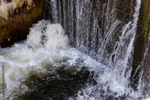 a leaking old wooden dam with a lot of holes