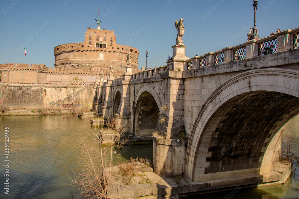 Rome, Italy - 02 17 2020. View of Castel Sant'Angelo and the Ponte Sant'Angelo bridge over the Tiber River. Rome, Italy - 02 17 2020. View of Castel Sant'Angelo and the Ponte Sant'Angelo bridge over the Tiber River.