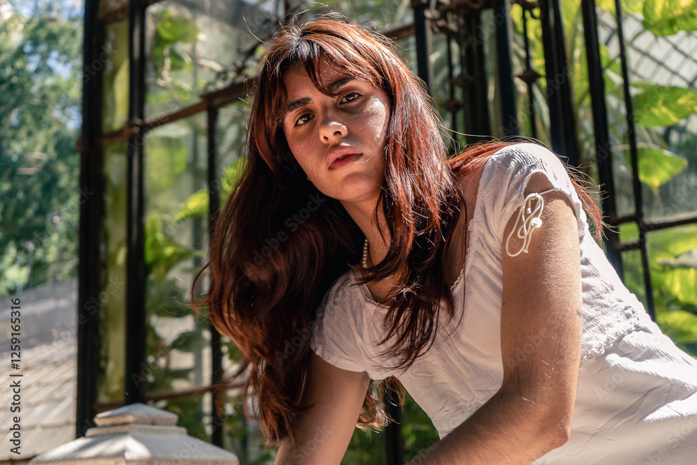 Naklejka premium Young latin woman posing in botanical garden setting