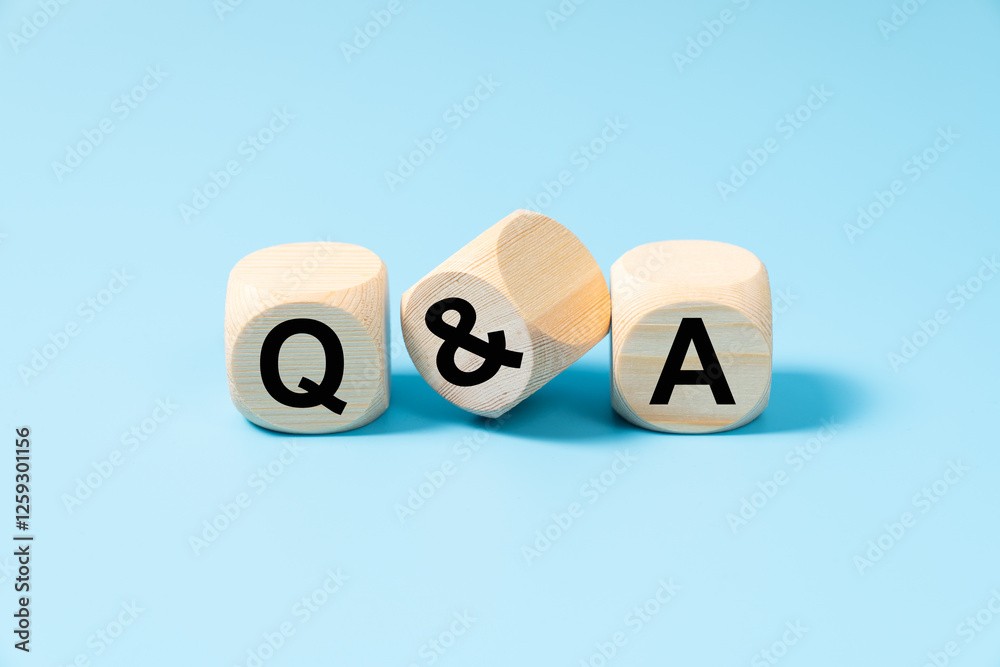 Fototapeta premium Questions and answers concept with three wooden blocks on light blue background with letters Q and A