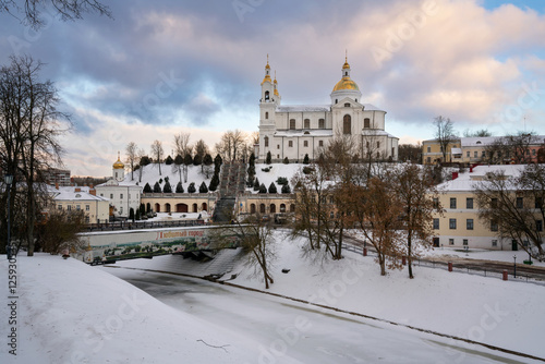 View of the Assumption Mountain, the Holy Spirit Monastery and the Holy Assumption Cathedral on the bank of the Vitba river on a sunny winter day, Vitebsk, Belarus photo