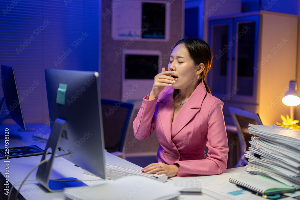 A woman in a pink jacket is sleeping at her desk A woman in a pink jacket is sleeping at her desk