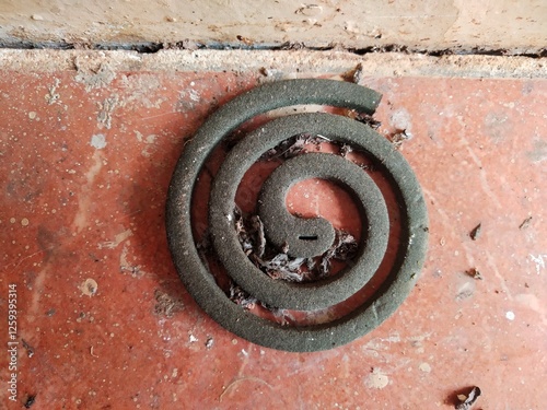 Dust-Covered Mosquito Coil Abandoned