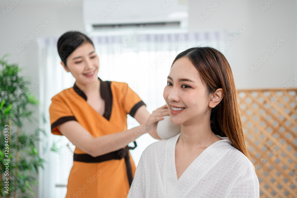 Asian beautiful woman getting shoulder and back massage at beauty spa. Asian beautiful woman getting shoulder and back massage at beauty spa.