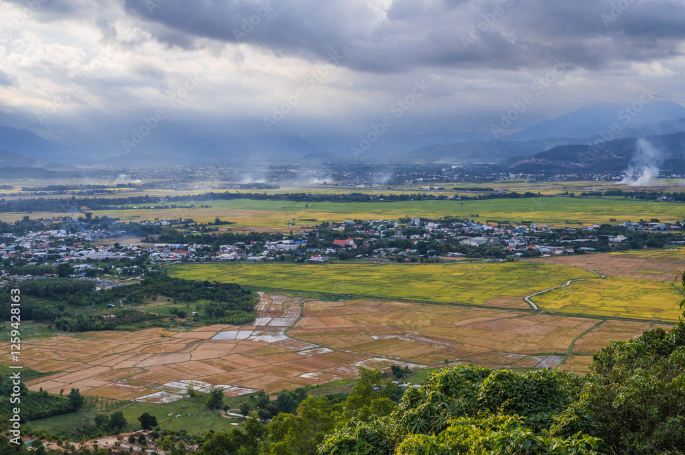 Fototapeta premium top view of rice fields with villages on background of mountains in Vietnam in Asia.