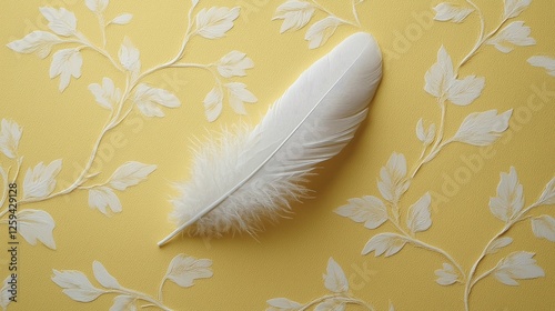 Elegant white feather resting on a textured yellow background with leaf patterns, creating a serene ambiance