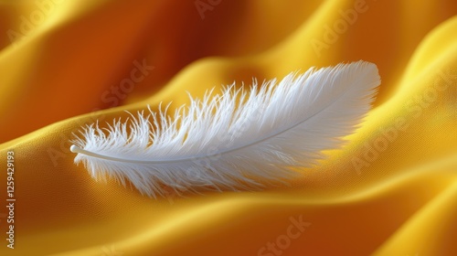 A delicate white feather resting on luxurious golden fabric, creating a serene and elegant atmosphere