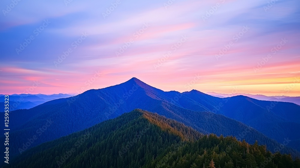 Obraz premium Majestic Mountain Range Under a Colorful Sunset Sky with Peaks