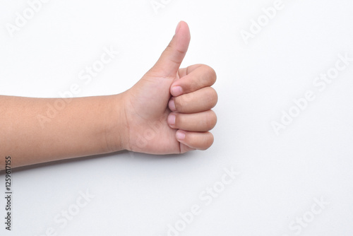 Child hand gesture giving thumbs up, like.Isolated on white background. Design elements. Concept of success or victory