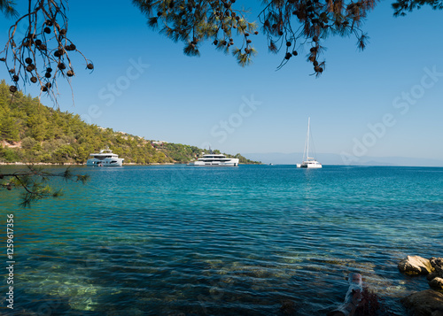 Fototapeta Naklejka Na Ścianę i Meble -  Yachts in Paradise Bay ( Turkish: Cennet Koyu ) is a quiet turquoise beach on the Bodrum peninsula. Aegean coast. Turkey holidays and travel. Mugla city, Turkey country