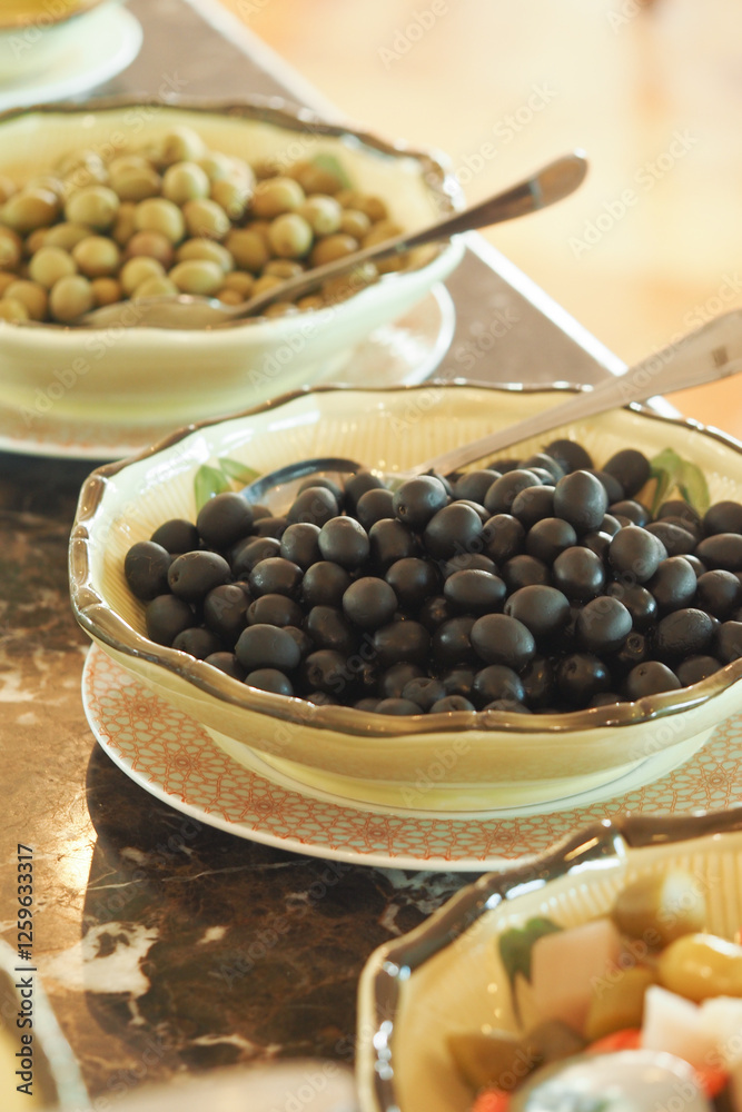 Olive selection on display at a Mediterranean restaurant buffet Olive selection on display at a Mediterranean restaurant buffet