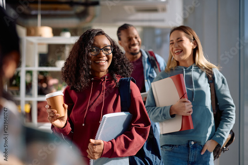 Happy black student and her friends at university. photo