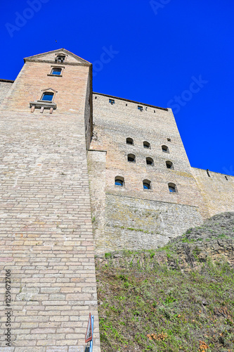 Narva Castle, Hermann's Fortress or ‘Hermanni linnus’ medieval fortress in Narva, Estonia in summer under a blue sky as a historical sight on the Narva River on the border with Russia photo