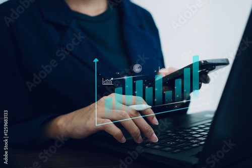A businesswoman uses a keyboard to plan and display charts showing her business growth.