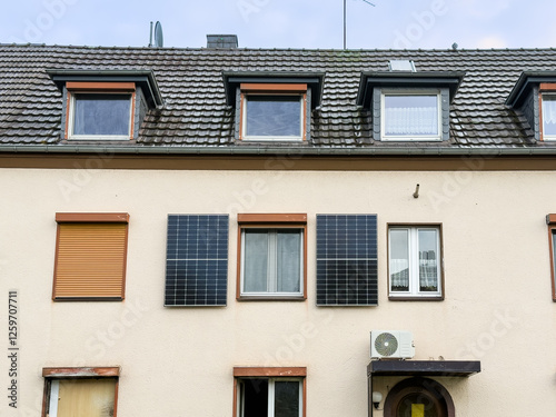 Zwei Solarpanele an einer Hausfassade eines Mehrfamilienhaus in Hilden, Deutschland photo