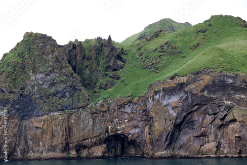 Steep cliff on the coast of Heimaey island- Vestmannaeyjar- Westman Islands-Iceland    photo