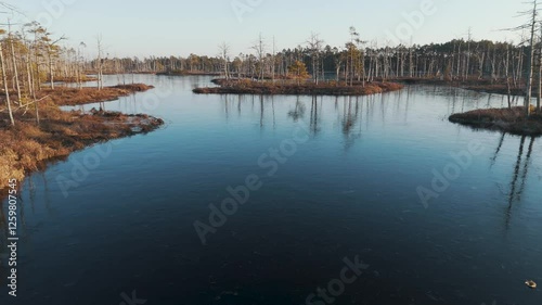 Cena Moorland Footpath Viewing Tower, Frozen Lake Skaists in Winter Aerial View. Latvia Second Largest Bog With 5 Km Long Footpath Trail. Cena Bog and Iced Lake Skaists With Islands at Winter photo