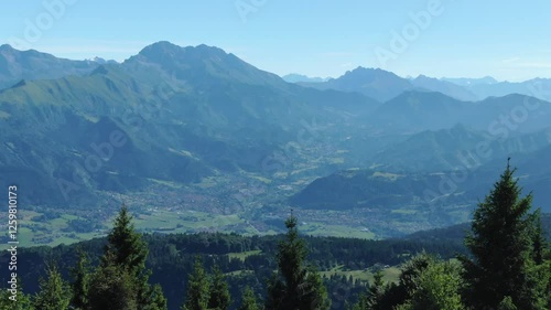 Green mountains with valley in background, plateau, Rovetta landscape, Lombardy in Italy. Aerial forward and panoramic view photo