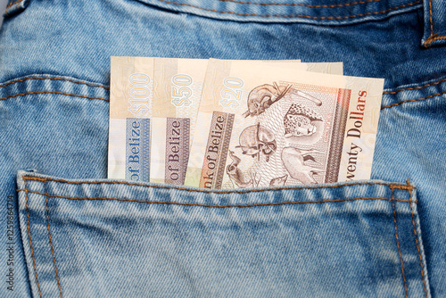 Belizean dollar in the pocket of blue jeans photo