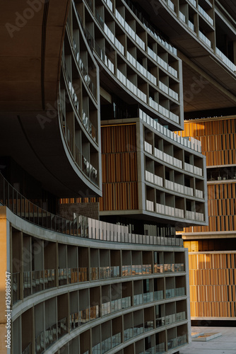 A close up architectural shot of a modern luxury hotel with curved balconies and geometric design. The intricate facade and lighting highlight the elegance of contemporary architectecture photo