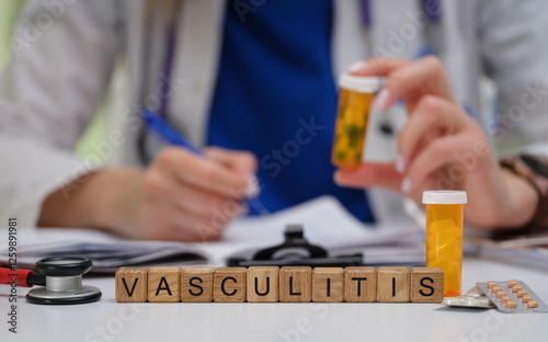 A dedicated healthcare professional meticulously prepares vasculitis medications while carefully taking notes