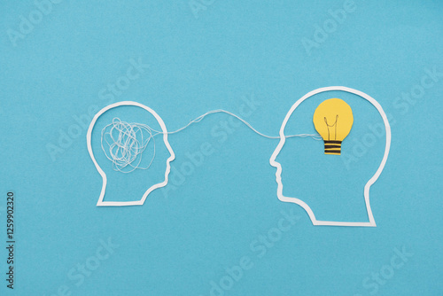 White outline head Silhouettes with Tangled Threads and Light Bulb on Blue Background connected by thread, Conceptual Interaction Between Confusion and Enlightenment