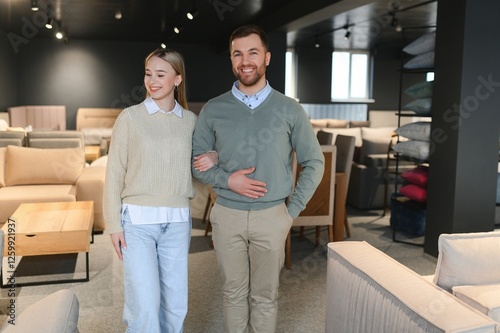 Couple choosing sofa and pillows at furniture store photo