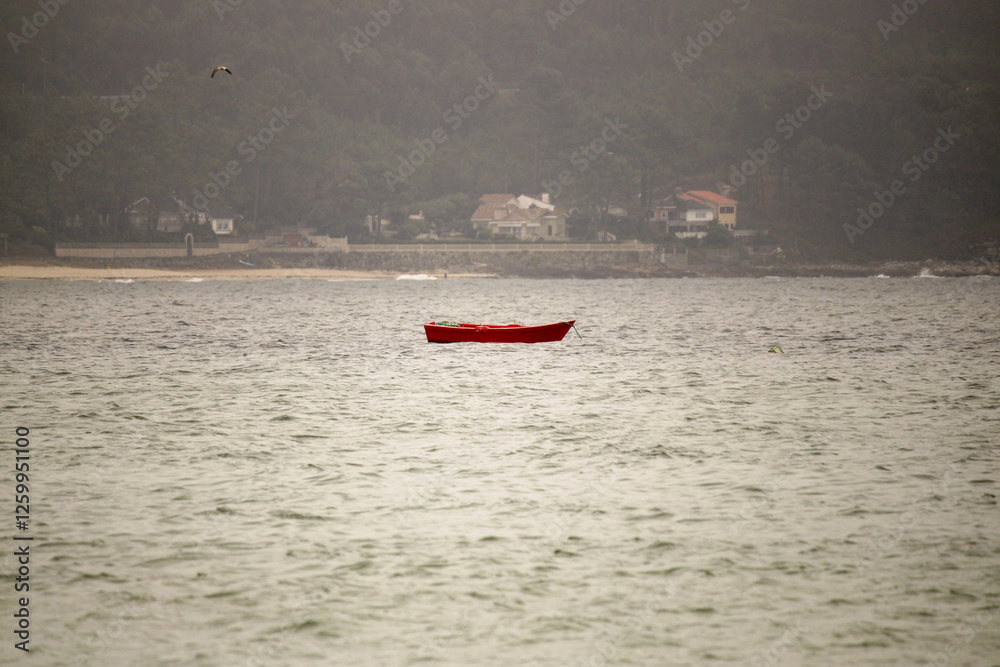Fototapeta premium Red Boat Floating on Calm Ocean Waters in Fog