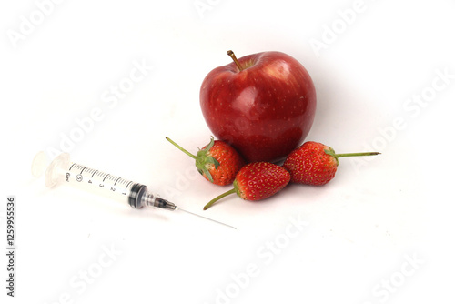 syringe fruit of red apple and strawberry healthy food containing mineral and vitamin c