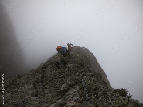 Veiled in mist, Via Ferrata degli Artisti presents a ghostly challenge, with the Alpi Liguri's peaks barely visible through the Ligurian fog. photo