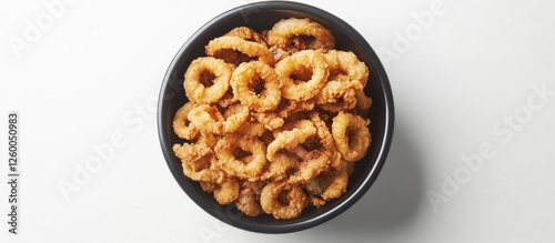 Fried calamari served in a round black bowl against a white background showcasing golden crispy texture and inviting presentation of seafood dish