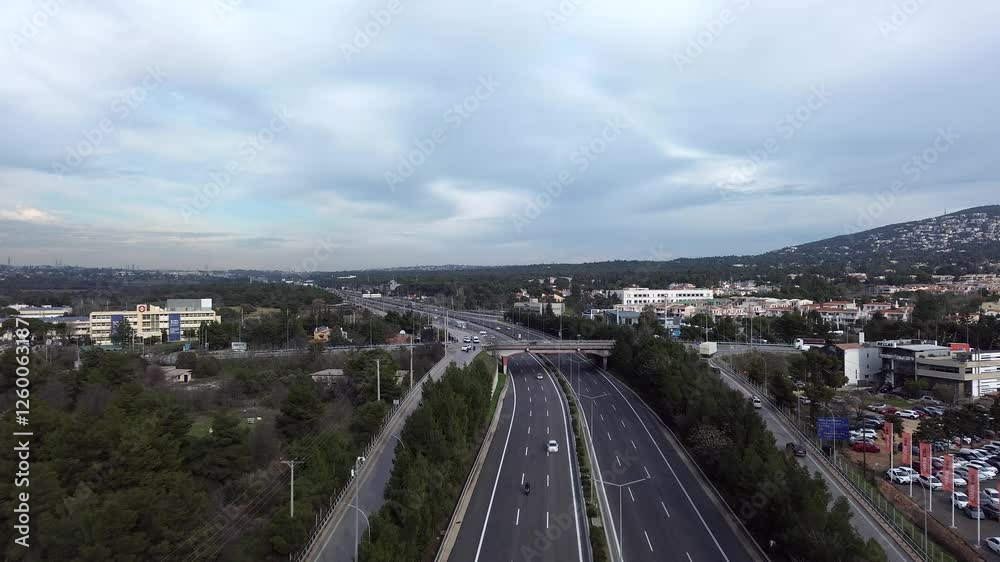 Aerial wide view of Varimpompi junction of national highway of Greece. Push in high angle shot, on cloudy overcast day with low traffic 4K Aerial wide view of Varimpompi junction of national highway of Greece. Push in high angle shot, on cloudy overcast day with low traffic 4K