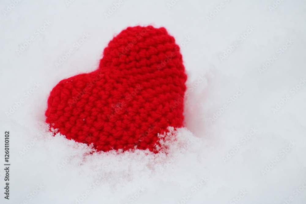 A knitted heart can be a symbol of tenderness and warmth on cold winter days. A knitted heart can be a symbol of tenderness and warmth on cold winter days.