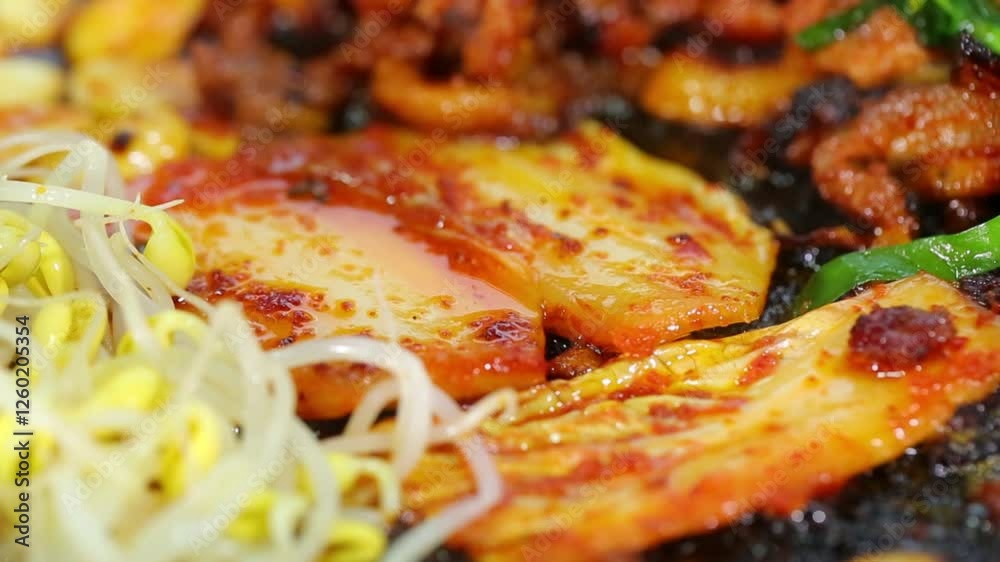 Garlic, kimchi and bean sprouts sizzling in a pan Garlic, kimchi and bean sprouts sizzling in a pan