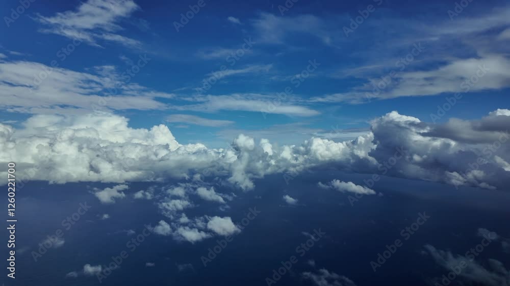 POV overflying the Mediterranean Sea under a deep blue sky with some storm clouds ahead. Aerial footage taken from a jet airplane cockpit. 4K 60FPS POV overflying the Mediterranean Sea under a deep blue sky with some storm clouds ahead. Aerial footage taken from a jet airplane cockpit. 4K 60FPS