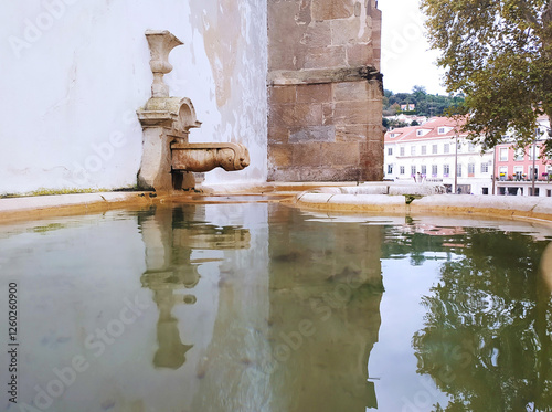 Fountain in an ancient historical building. Monastery with a place for water. photo