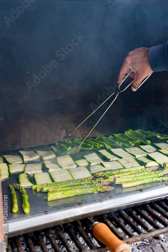 Barbecue of green peppers, zucchini and green asparagus. Outdoor smoked grill. BBQ. Vertical image.