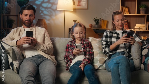 Family mother father daughter girl kid child parents man woman relaxing in home night evening on couch using mobile phones apps social media scrolling smartphones gadgets addiction dependency overuse