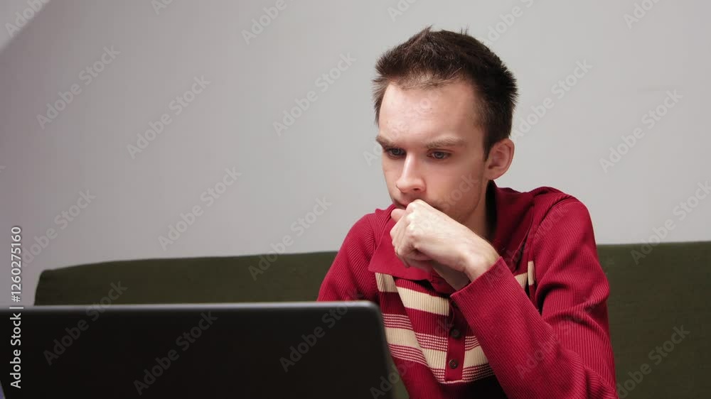 Young man engaged in online video meeting using laptop at home Young man engaged in online video meeting using laptop at home