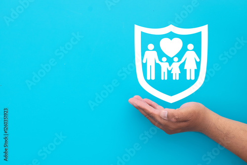 Life insurance and family protection concept.,Hand holding family icon in guard with copyspace.,security, healthcare, financial coverage, risk management, personal safety idea.