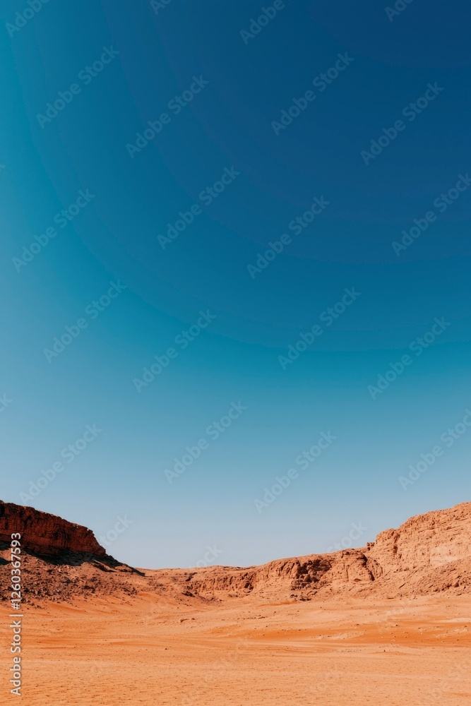 Fototapeta premium Expansive Desert Landscape Under a Vivid Blue Sky