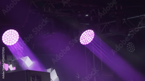 Stage lighting setup with magenta hues creating vibrant atmosphere for live event or concert.