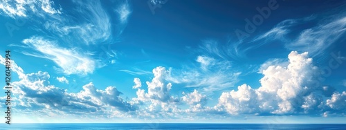 Serene blue sky with fluffy white clouds offering ample space for text or graphic overlays in a tranquil natural setting photo