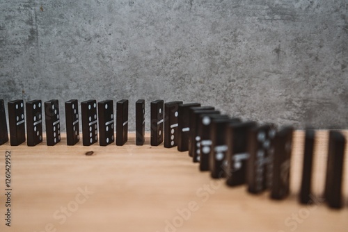 Domino effect in motion on wooden surface