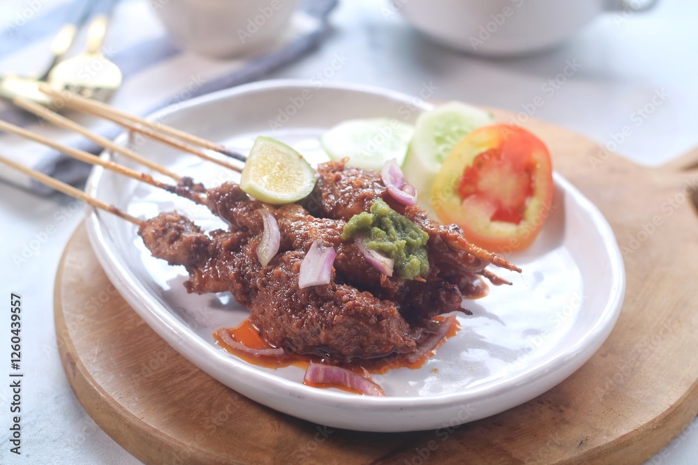 sate ayam or chicken satay, famous traditional Indonesian food, chicken meat on bamboo sticks and grilled, served on a plate sate ayam or chicken satay, famous traditional Indonesian food, chicken meat on bamboo sticks and grilled, served on a plate
