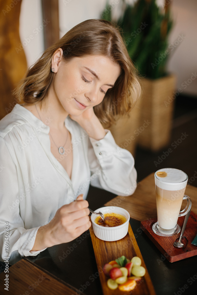 Woman Enjoying Dessert and Latte in a Cozy Cafe Setting Woman Enjoying Dessert and Latte in a Cozy Cafe Setting