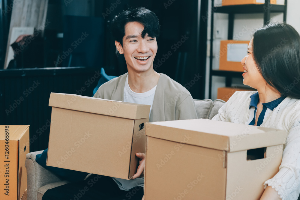 Smiling couple unpacking boxes in new house Smiling couple unpacking boxes in new house